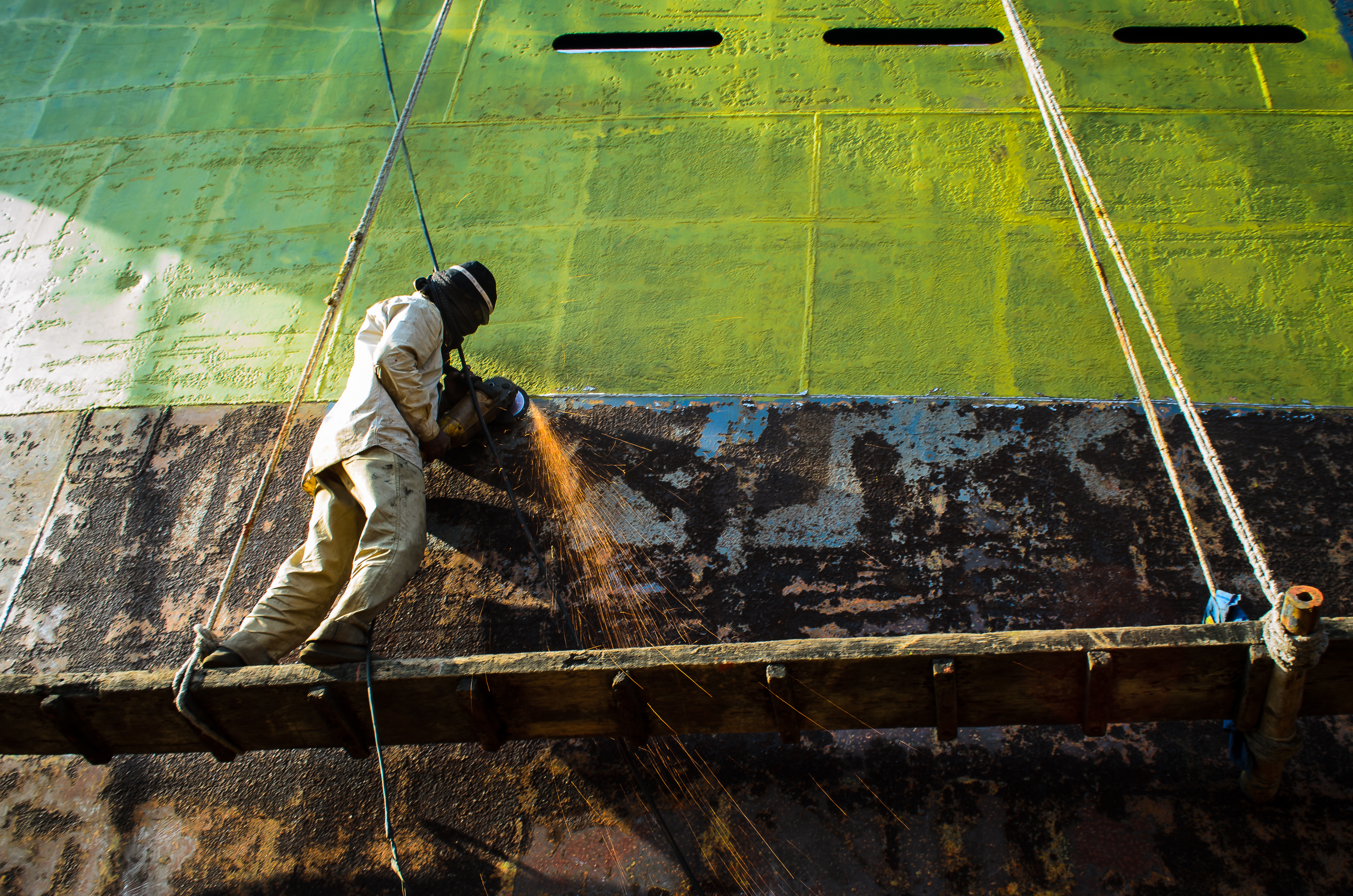 man-welding-a-part-of-a-ship-in-bangladesh-2023-11-27-05-31-09-utc