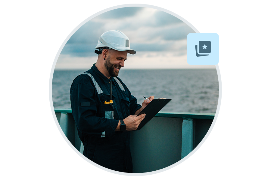 Crew member inspecting deck with a tablet.